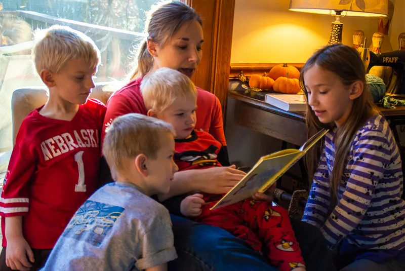Mother Reading to her four children.