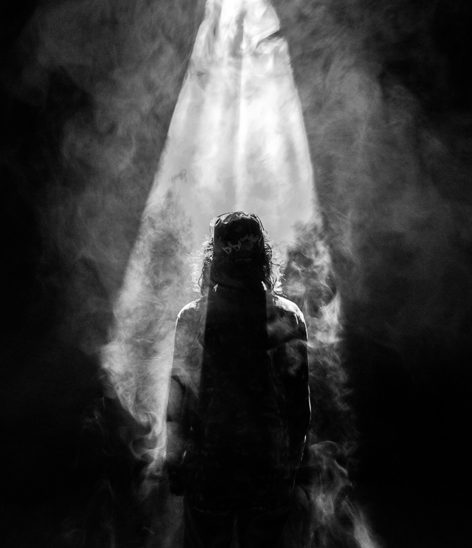 Black and White silhouette of Jesus in rays of sunshine, as if He had just risen from the grave.