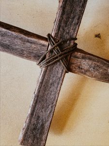 The cross of Jesus ties together with ropes. Shows the cross is empty as well as a terrible instrument of torture.