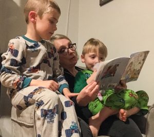 Grandmother Reading book to grandchildren