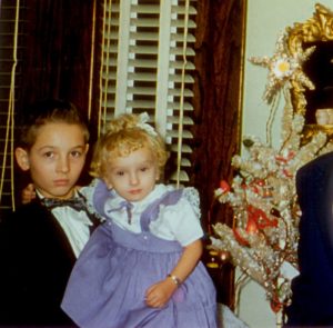 two children with a vintage aluminum Christmas tree