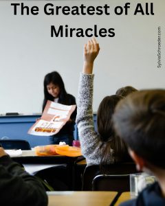 school girl raising her hand in class.